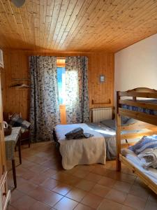 a bedroom with two beds and a bunk bed at La Tourtette in Le Dévoluy