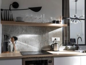 a kitchen with a counter with a stove top oven at Secret Contemporary Courtyard in Monte Carlo