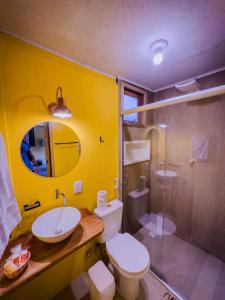 a bathroom with a sink and a toilet and a shower at Canoa Abraão in Abraão