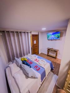 a bedroom with a bed with a hello kitty pillow at Canoa Abraão in Abraão