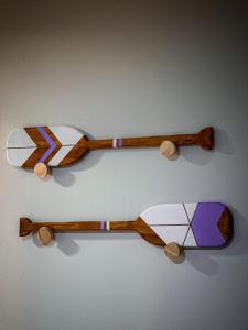two wooden spoons are hanging on a wall at Canoa Abraão in Abraão