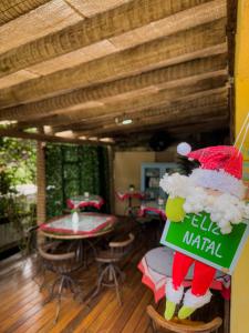 a santa claus sign in front of a restaurant at Canoa Abraão in Abraão