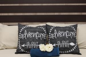 two pillows sitting on top of a bed at GLESTER GUEST HOUSE in Pretoria