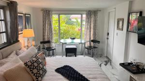 a living room with a couch and a table at Paradise Gardens-Wilton Manors-Clothing Optional- Male only in Fort Lauderdale