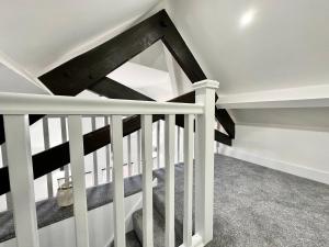 a white and black staircase in a house at Luxury Duplex City Centre Apartment in Leeds