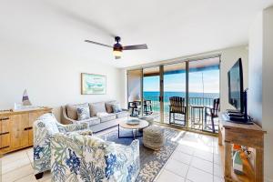 a living room with a couch and a tv at Island Princess 704 in Fort Walton Beach
