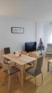 a dining room with a table and a christmas tree at Apartamento Ceuta in Murcia