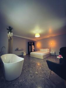 a bedroom with a bed and a tub in a room at Imperial Hotel in Bukovel