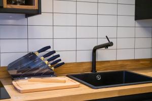a kitchen counter with a sink and a cutting board at Kirkgate Suites - Signature Suite in Leeds