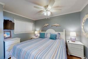 a bedroom with a bed with a ceiling fan at Sea Side Villas 171 in Hilton Head Island