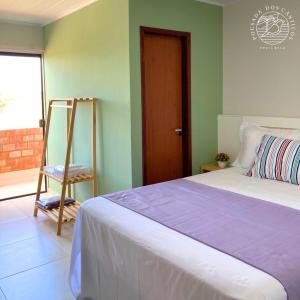 a bedroom with a bed and a ladder and a window at Pousada dos Cânticos in Barra