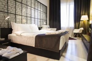 A bed or beds in a room at Magnova Studios