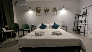 a bedroom with a bed with two towels on it at Chu-Cha's Samui - Boutique stay in Bophut