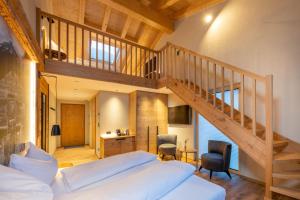 a bedroom with a large bed and a staircase at Mountain Lodge in Grächen