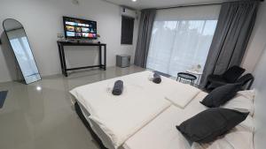 a large room with a bed and a television at Chu-Cha's Samui - Boutique stay in Bophut