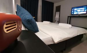 a bedroom with a bed with a blue pillow at Chu-Cha's Samui - Boutique stay in Bophut