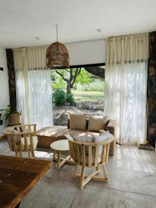 a living room with a couch and a table and chairs at Casa Simona in Las Rabonas