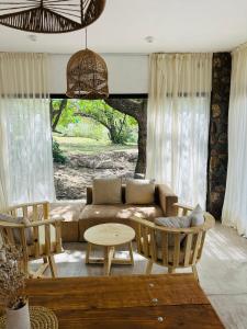 a living room with a couch and chairs and a table at Casa Simona in Las Rabonas