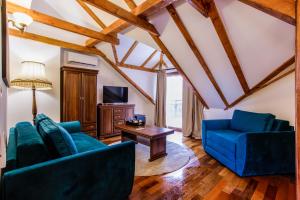 a living room with two blue couches and a table at Villa 1927 in Belgrade