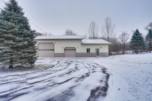 a snow covered driveway leading to a garage at Peaceful Ellsworth Vacation Rental with Grill 