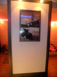 a framed picture of the golden gate bridge on a wall at Арбат in Almaty