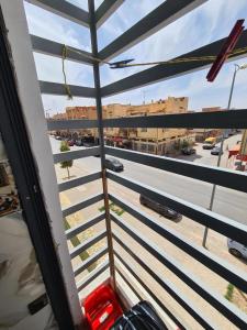 a view of a street from a window with a train at Oujda hay Salam doha in Oujda