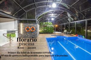 una piscina con un edificio con techo abierto en Cosmos 100 Hotel & Centro de Convenciones - Hoteles Cosmos en Bogotá