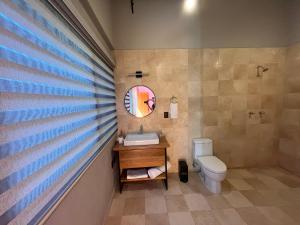 a bathroom with a sink and a toilet at Suites Patio Antequera in Oaxaca City +83 photos