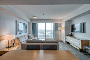 a living room with a couch and a tv at The Residential Suites at the Ritz-Carlton, Fort Lauderdale #1510 in Fort Lauderdale
