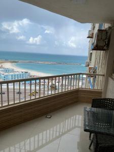a balcony with a view of the beach and the ocean at City Square in Alexandria