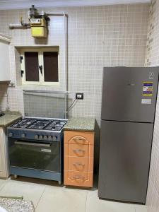 a kitchen with a stove and a refrigerator at City Square in Alexandria