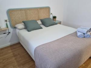 a bedroom with a large white bed with two pillows at El Rincón del Alba in Benasque