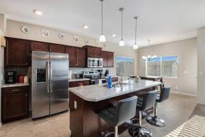a kitchen with stainless steel appliances and a large island at Stylish Retreat Master Suite in Omaha