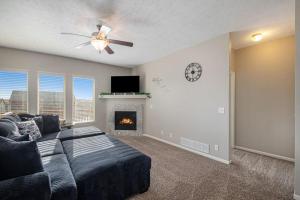 a living room with a couch and a fireplace at Stylish Retreat Master Suite in Omaha