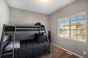 a bedroom with bunk beds and a dog laying on a couch at Stylish Retreat Master Suite in Omaha