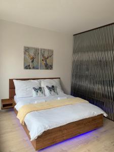 a bedroom with a bed with two cats on the pillows at O2 Arena - Alex Apartment Praha in Prague