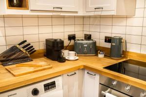 a kitchen with a counter top with a coffee maker at Kirkgate Suites - Stylish City Centre Apartment in Leeds