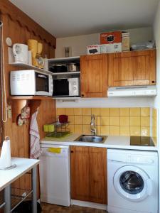 een keuken met een wastafel en een wasmachine bij LA Source Blanche in Saint-Jean