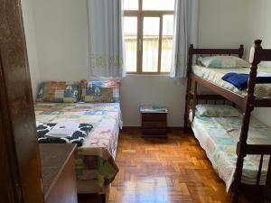 a bedroom with two bunk beds and a window at Pousada Luar da Canastra in Piauí