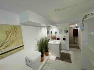 a white bathroom with a toilet and a sink at Apartamento panorámico vista al mar in Las Galeras +21 photos
