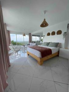 a bedroom with a bed and a living room at Apartamento panorámico vista al mar in Las Galeras +12 photos