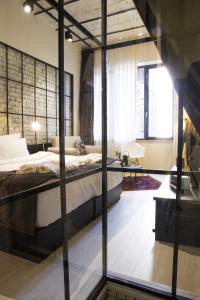 A bed or beds in a room at Magnova Studios