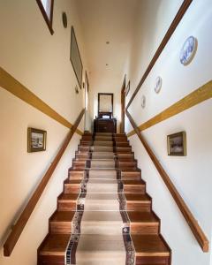 a staircase in a house with wooden floors and ceilings at Villa Arcturia in Nimfaíon