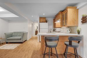 a kitchen with a counter and two bar stools at Comfortable Whitby 2 Bedroom Lower Suite in Whitby