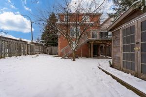 a yard covered in snow in front of a building at Comfortable Whitby 2 Bedroom Lower Suite in Whitby