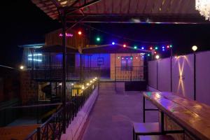 a bar with a wooden table and lights at night at Kotun: a spacious house in Gyumri in Gyumri
