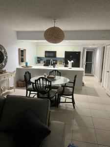 a living room with a table and chairs and a kitchen at Harbor View, short 7 minute walk to beach. in Vero Beach