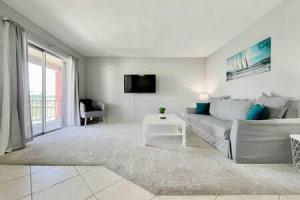 a living room with a couch and a table at Perfect Beach Getaway with Dock AND Pet Friendly in St Pete Beach