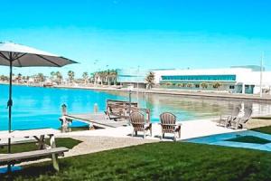 a pool with chairs and a table and an umbrella at Perfect Beach Getaway with Dock AND Pet Friendly in St Pete Beach