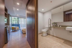 a bathroom with a toilet and a sink at El Tesoro Medellín Hab311 by Letoh in Medellín